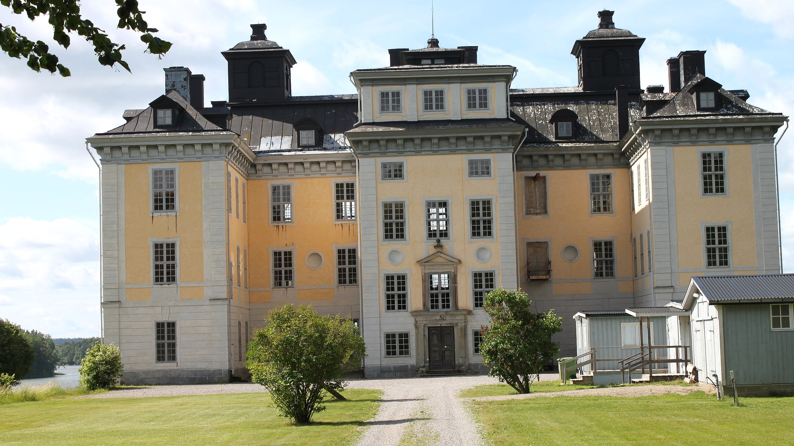 Mälsåkers Slott, a white Swedish baroque castle, leveled and composed for editorial balance